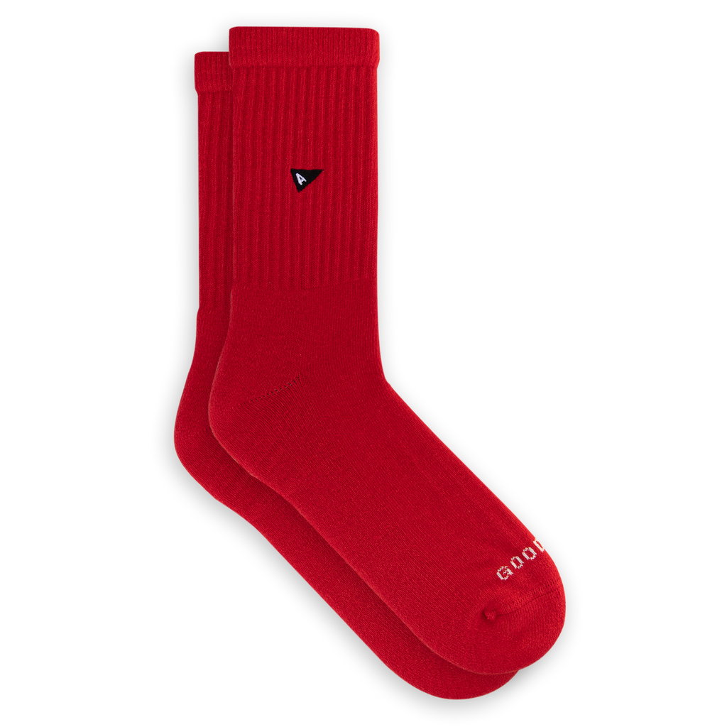 A pair of red Crew Sock - Matador socks showing a small black logo on the ribbed leg and text near the toe area.